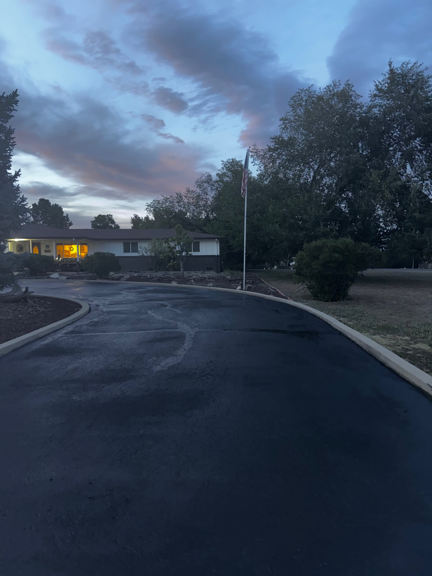 Smooth newly sealed residential driveway at dusk